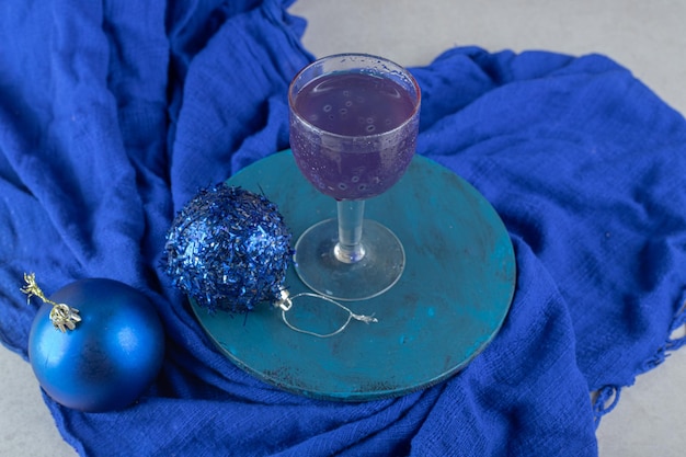Blue cocktail with glittery baubles on blue plate