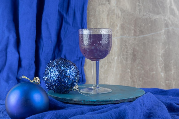 Blue cocktail with glittery baubles on blue plate