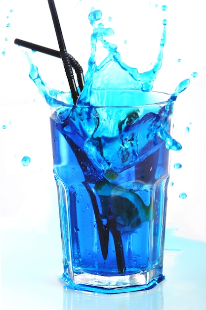 Blue cocktail with splashes isolated on white