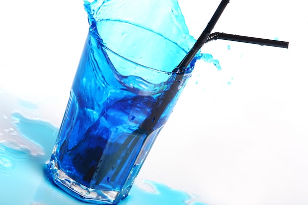 Blue cocktail with splashes isolated on white