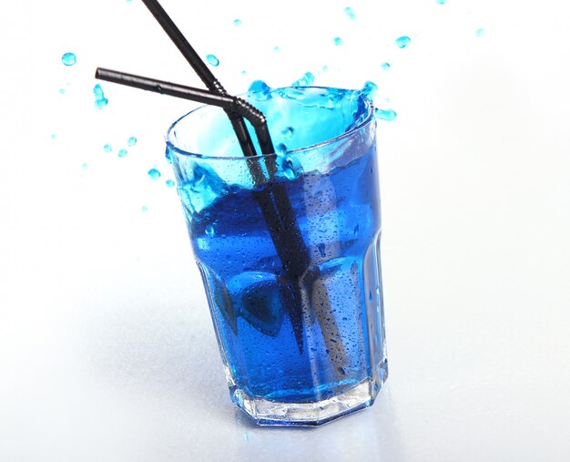 Blue cocktail with splashes isolated on white