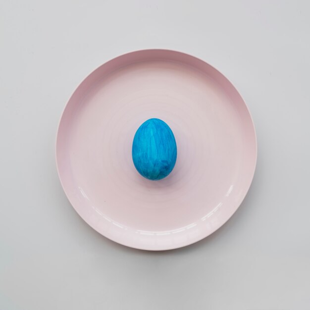 Blue colored egg on plate 