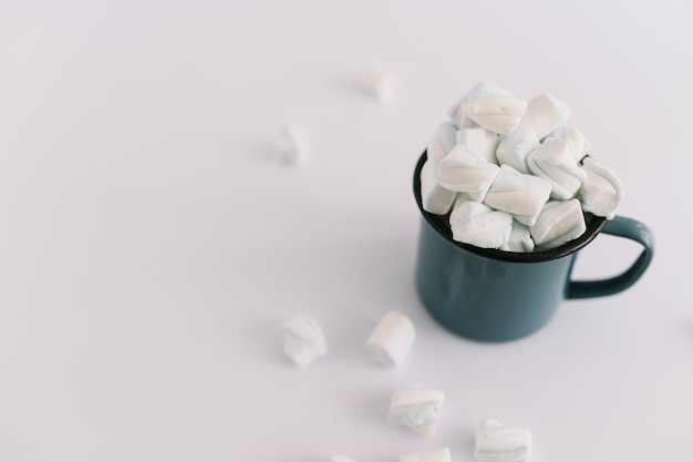 Blue cup full of soft marshmallows