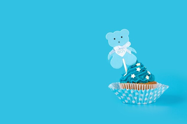 Blue cupcake for baby shower on blue background