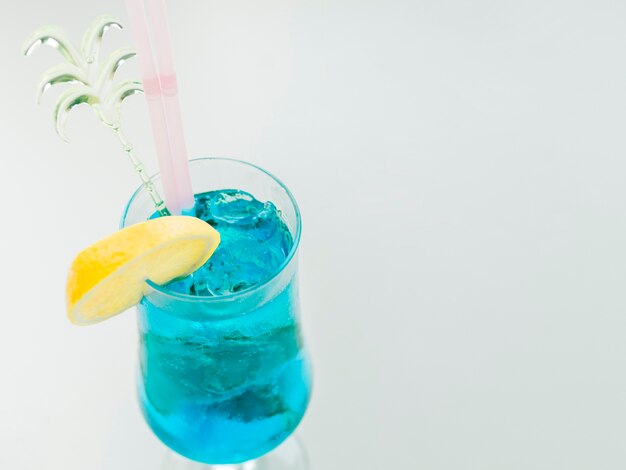 Blue curacao cocktail with lemon and ice