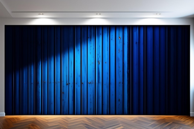 A blue curtain is on a wall in a room with a wooden floor.