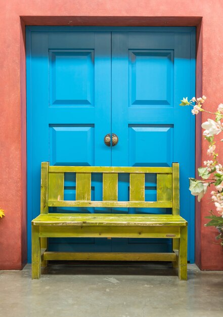 Blue door and yellow bench