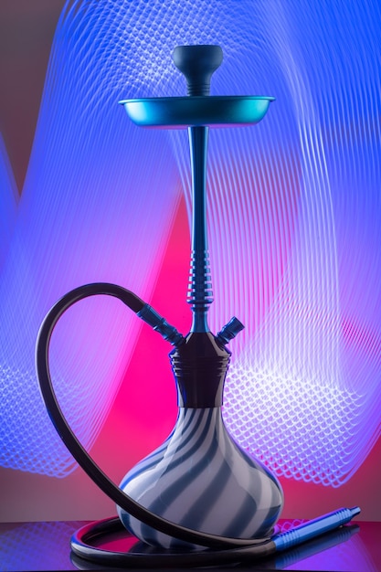 Free photo blue eastern hookah on colorful background. still life. copy space