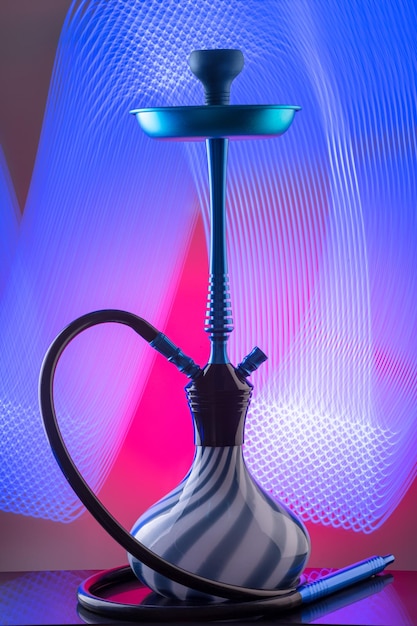 Blue eastern hookah on colorful background. Still life. Copy space