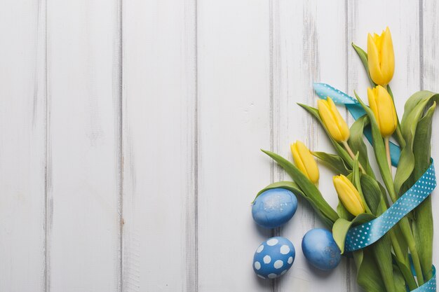 Blue eggs near tulips