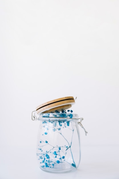 Free photo blue flowers in glass with cover on top