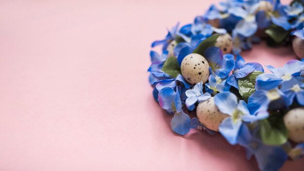 Blue flowers with eggs on table