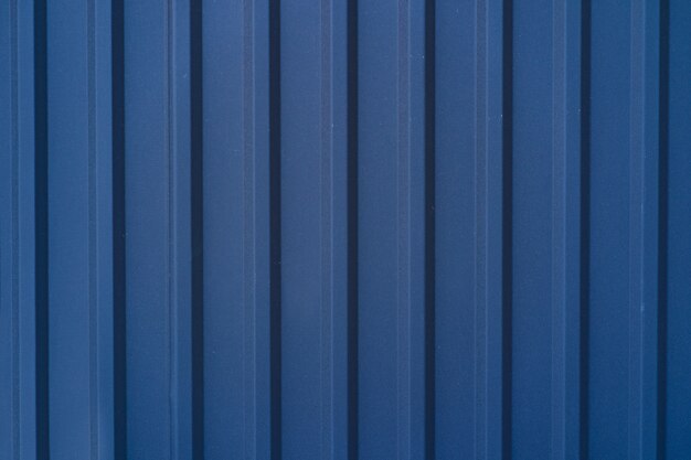 Blue galvanized tin fence lined background. Metal texture