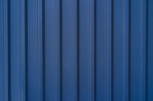 Blue galvanized tin fence lined background. Metal texture