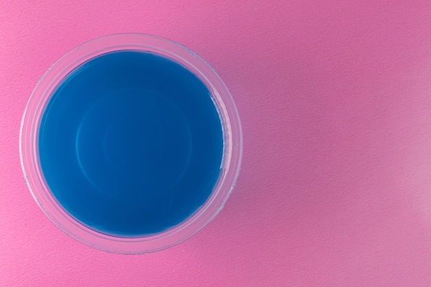 Free photo blue gelatin on the pink surface