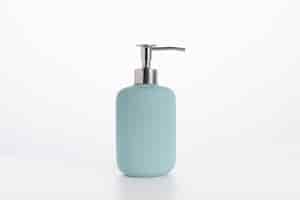 Free photo blue glass soap bottle isolated on a white wall