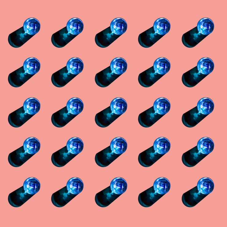 Free Photo blue glasses of liquid with shadow on colored background