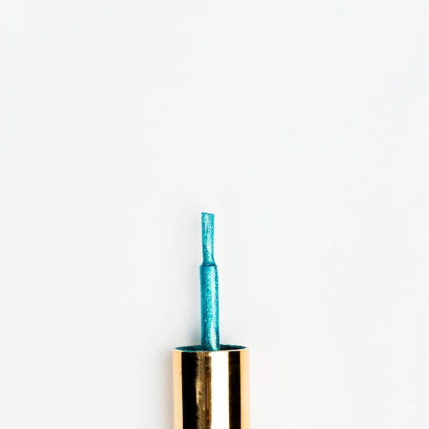 Blue glitter nail polish brush isolated on white background