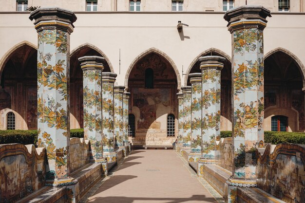 Blue, green, and yellow floral painted pillars lining up the hallway