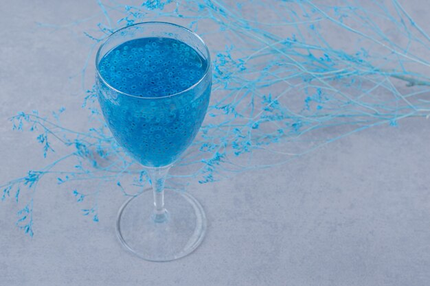 Blue homemade cocktail on grey surface