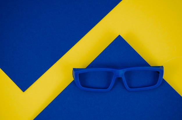 Blue kids eyeglasses on blue and yellow background
