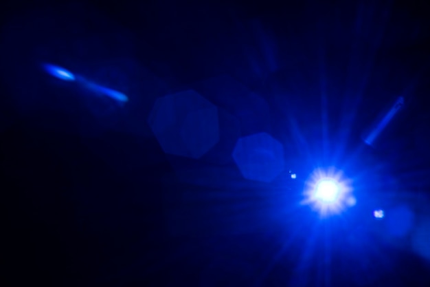 Blue lens flare effect on a black background wallpaper