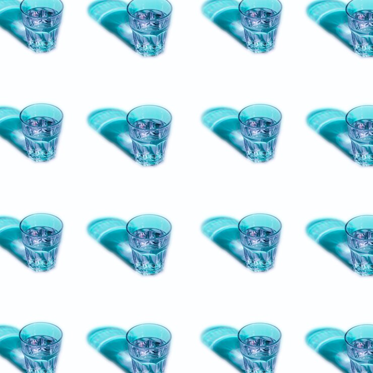 Free Photo blue liquid in glasses with shadow on white background