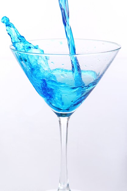 Blue liquid pouring into glass