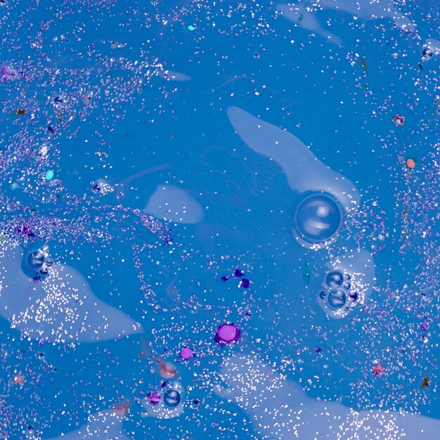 Blue liquid with colourful bits