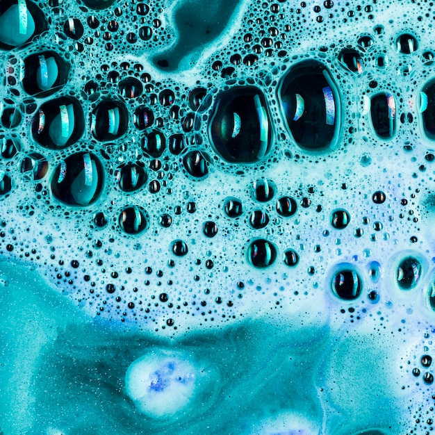Blue liquid with many blobs and foam 