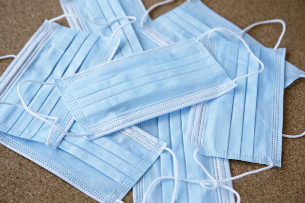 Blue medical masks on each other over the table