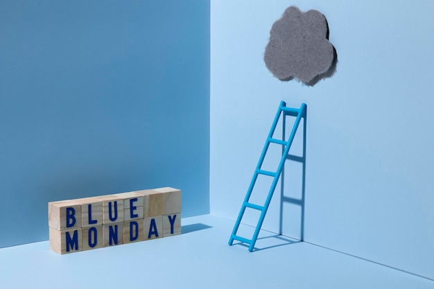 Free photo blue monday with ladder and wooden cubes