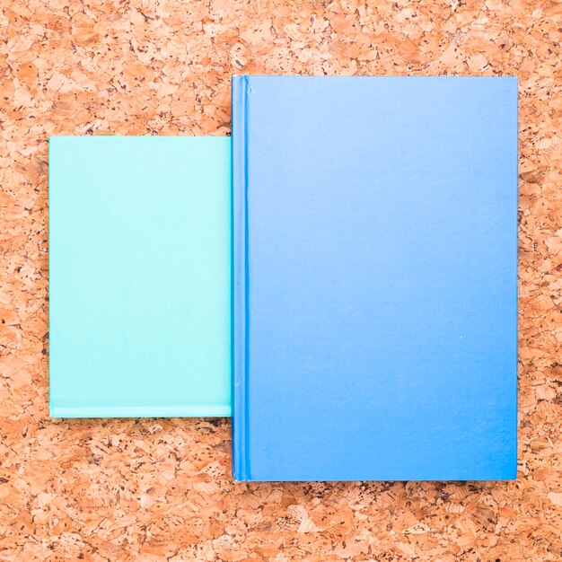 Blue notebooks on wooden desk