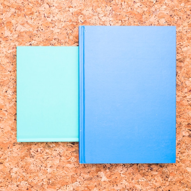 Blue notebooks on wooden desk