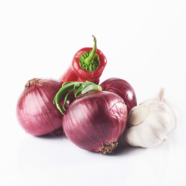 Blue onion garlic and hot red pepper isolated on white.