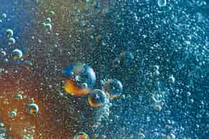 Free photo blue and orange abstract background with bubbles