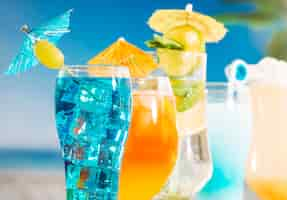 Free photo blue orange drinks with olive sliced lime mint in glasses