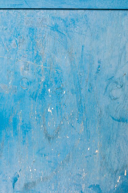 Blue paint on aged wooden surface