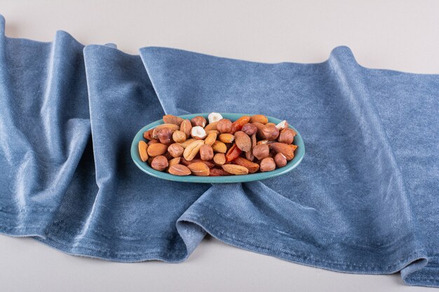 Blue plate of various organic nuts