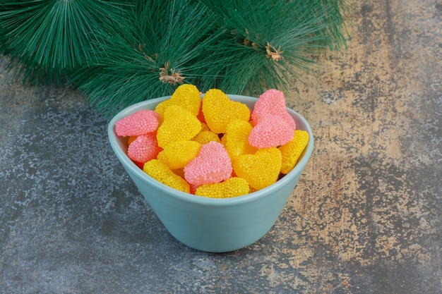 A blue plate with heart shaped sugary jelly candies. High quality photo