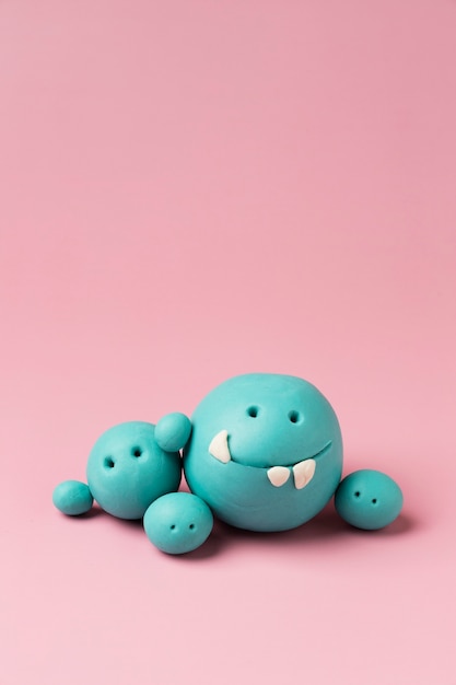 Free photo blue play dough monsters arrangement