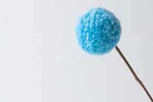 Free photo blue pom pom with white background