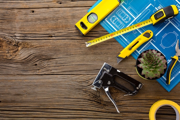 Blue print and set of tools on wooden background