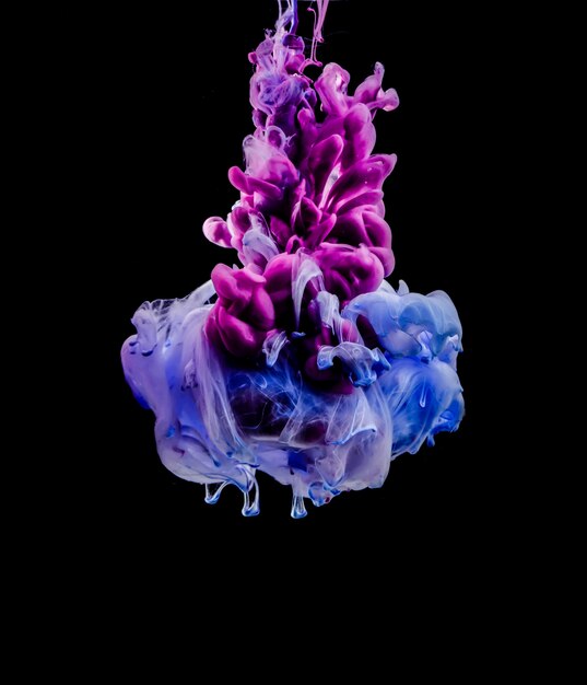 Blue and purple ink diluting in water