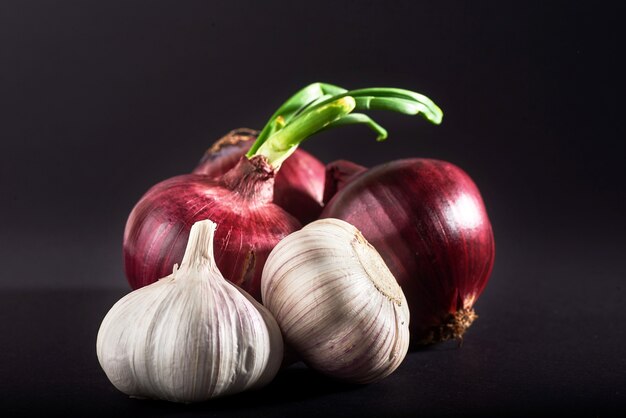 Blue purple onion and garlic isolated white on a black