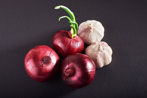 Blue purple onion and garlic isolated white on a black