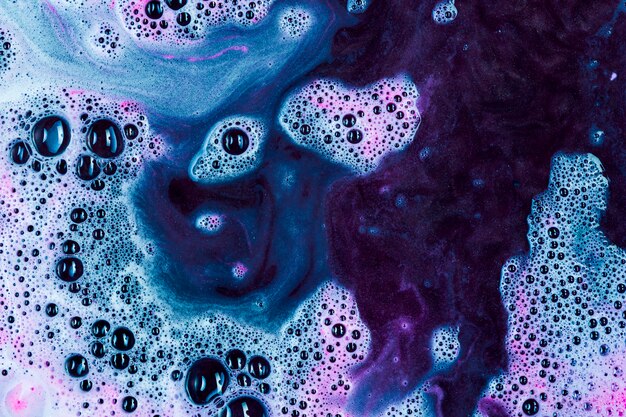 Blue and purple suds mixing