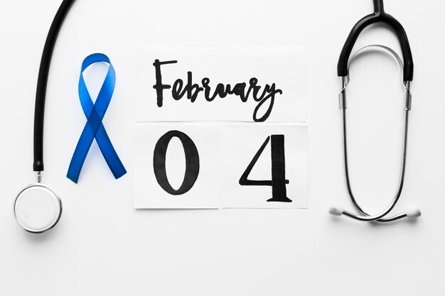 Blue ribbon near stethoscope and date