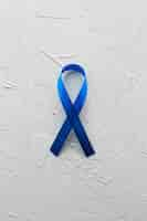 Free photo blue ribbon on plaster background