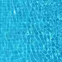 Free photo blue rippled water background in swimming pool